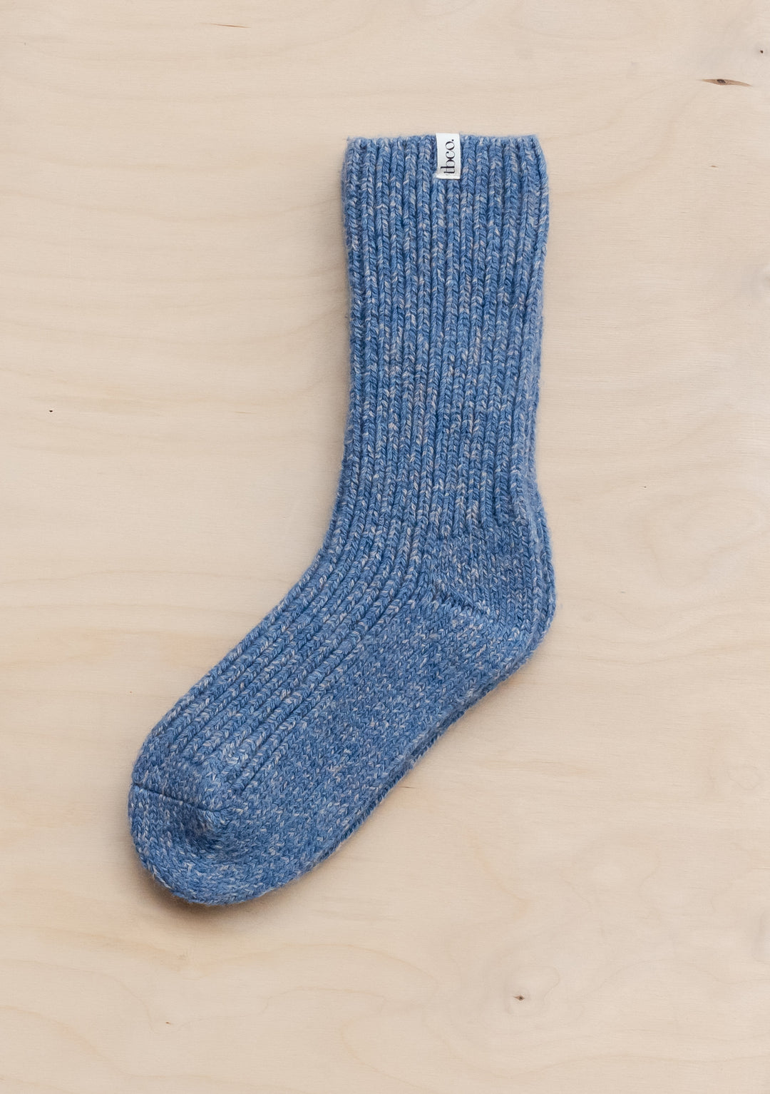 TBCo Cashmere & Merino Socks in Blue Fleck shown flat, displaying ribbed texture and speckled blue wool blend pattern