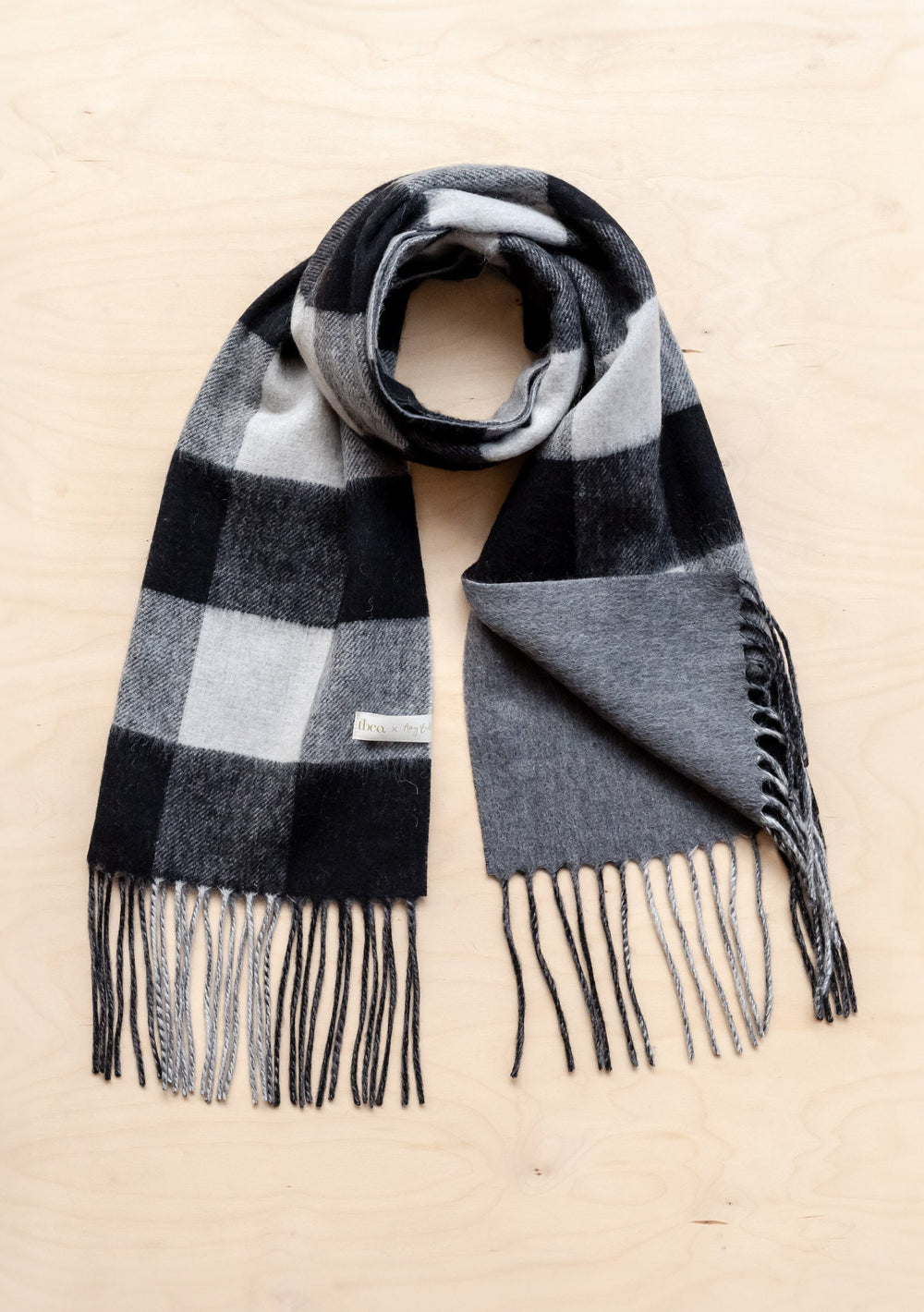 TBCo x Amy Bell Spencer 2.0 scarf in monochrome check pattern with charcoal reverse and tasselled fringe
