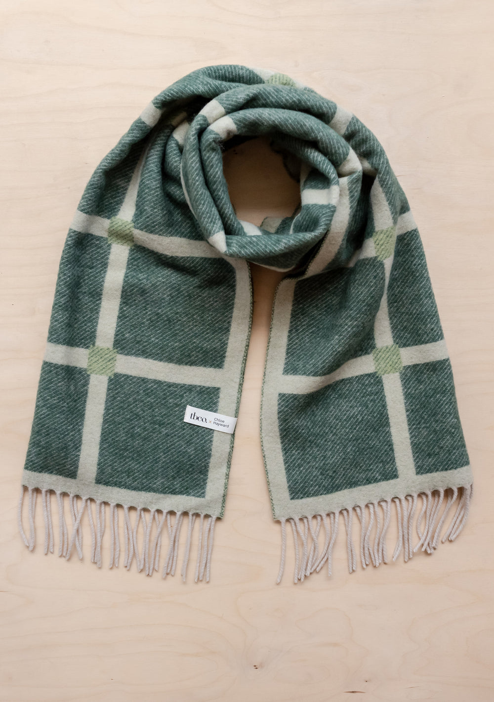 TBCo x Chloe Hayward reversible lambswool scarf in evergreen check pattern with cream grid lines and fringed edges