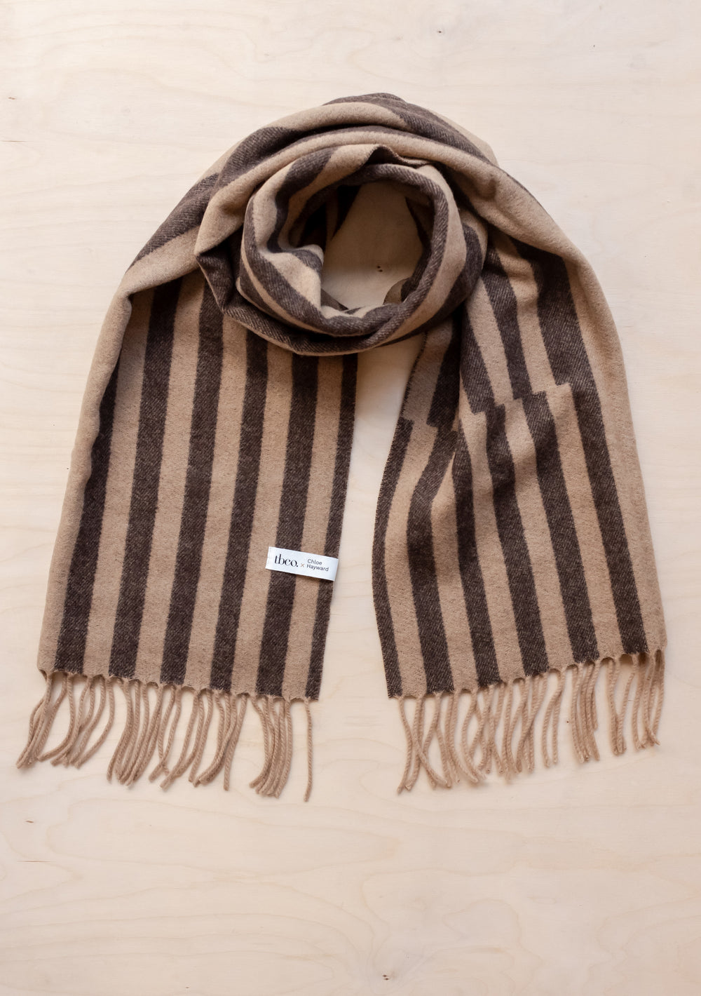 TBCo x Chloe Hayward lambswool scarf in espresso and camel stripe pattern with fringed edges, featuring geometric design