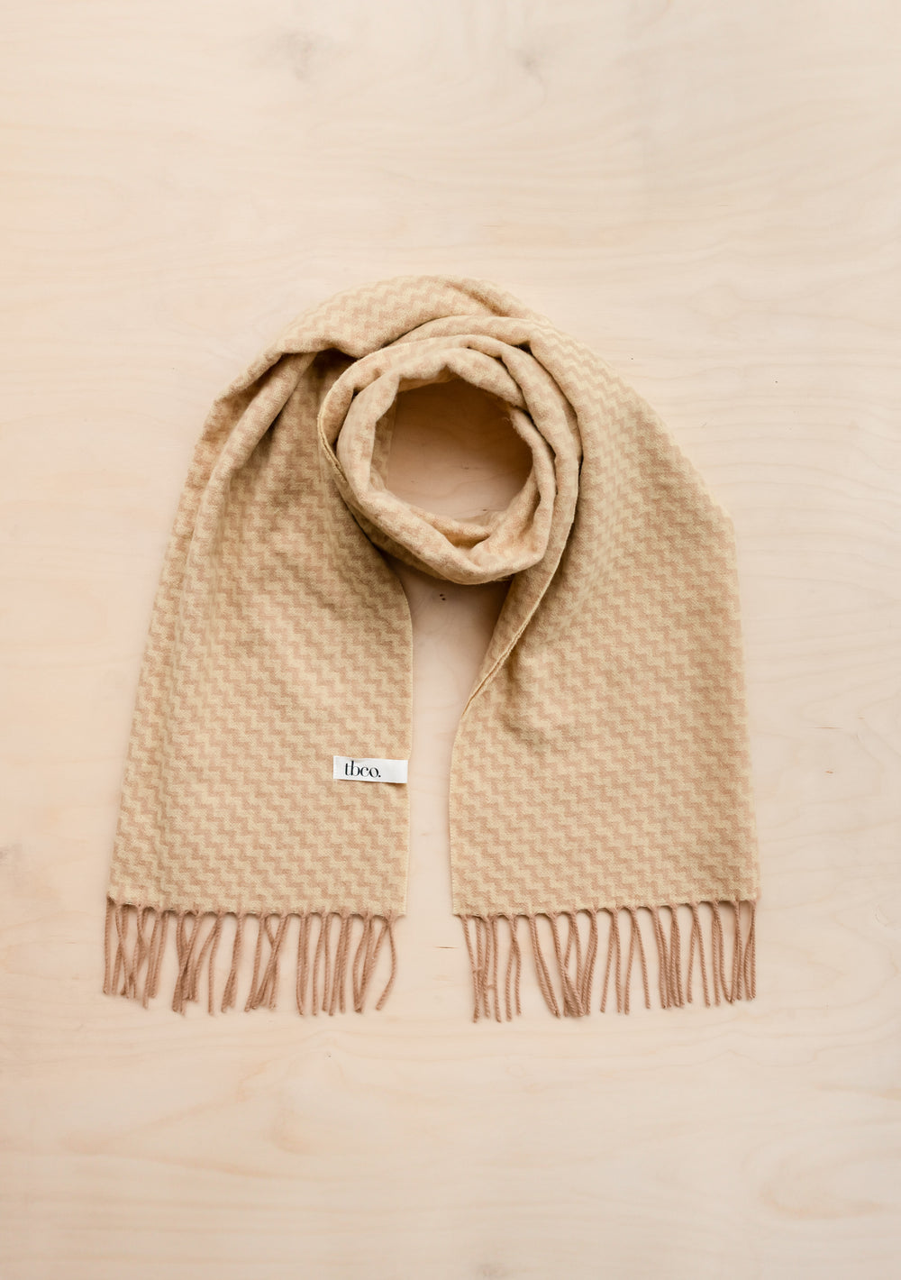 TBCo Lambswool Oversized Scarf in buttermilk and camel chevron pattern with fringed ends, displayed flat against neutral background