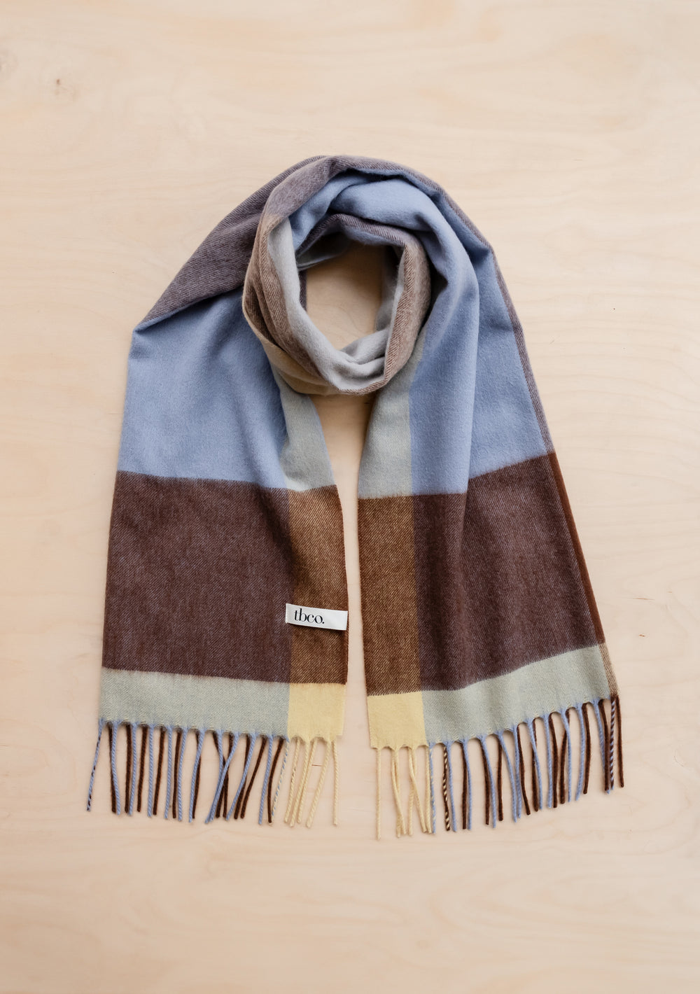 TBCo Lambswool Oversized Scarf in Lilac Edge Check featuring blue-lilac, chocolate brown and buttermilk yellow check pattern with fringe