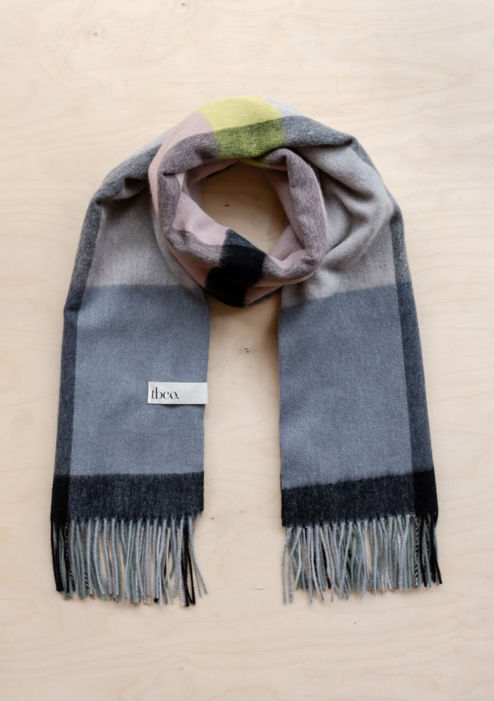 TBCo lambswool blanket scarf in slate modern check pattern featuring grey, rose and lime tones with fringed edges