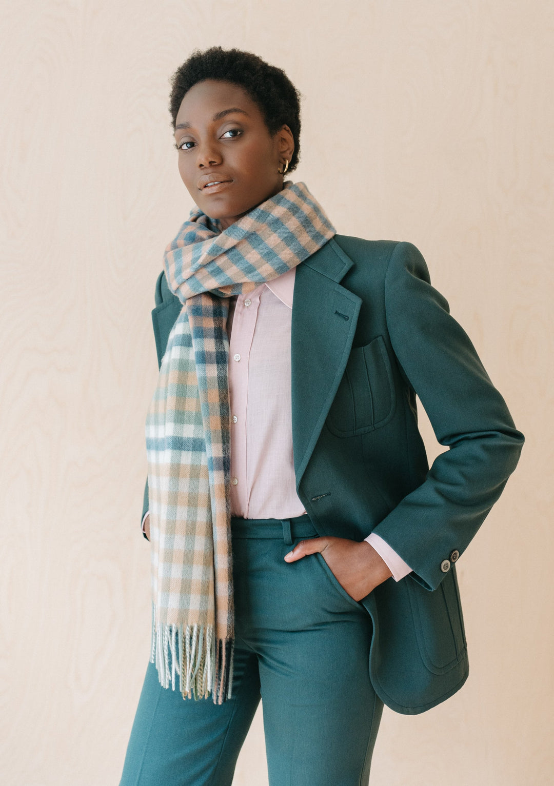 TBCo Lambswool Blanket Scarf in Olive Micro Gingham styled with green suit and pink shirt, showcasing fringed edges and gingham pattern