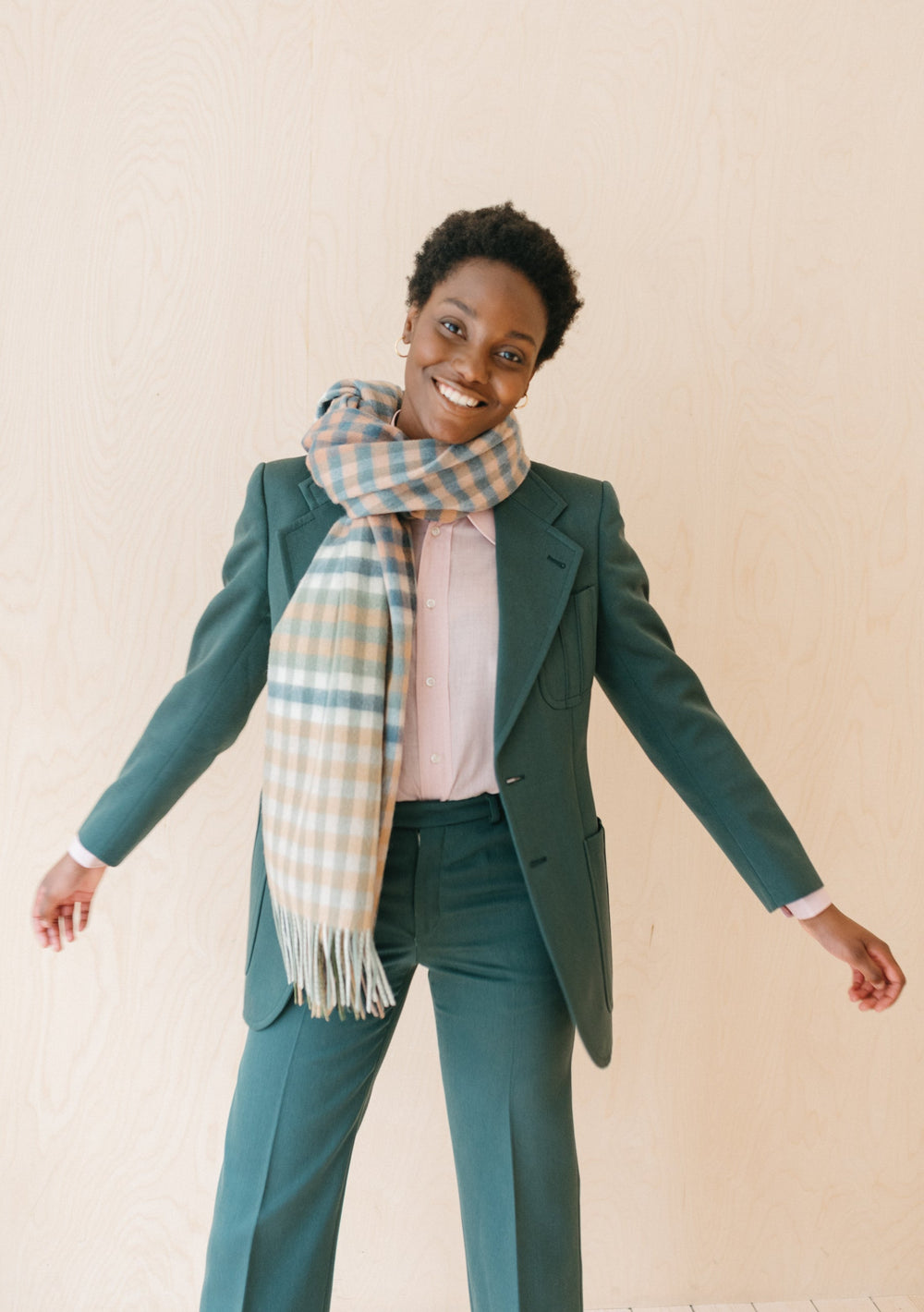 TBCo Lambswool Blanket Scarf in olive micro gingham styled with green suit and pink shirt, showcasing fringe detail and pattern