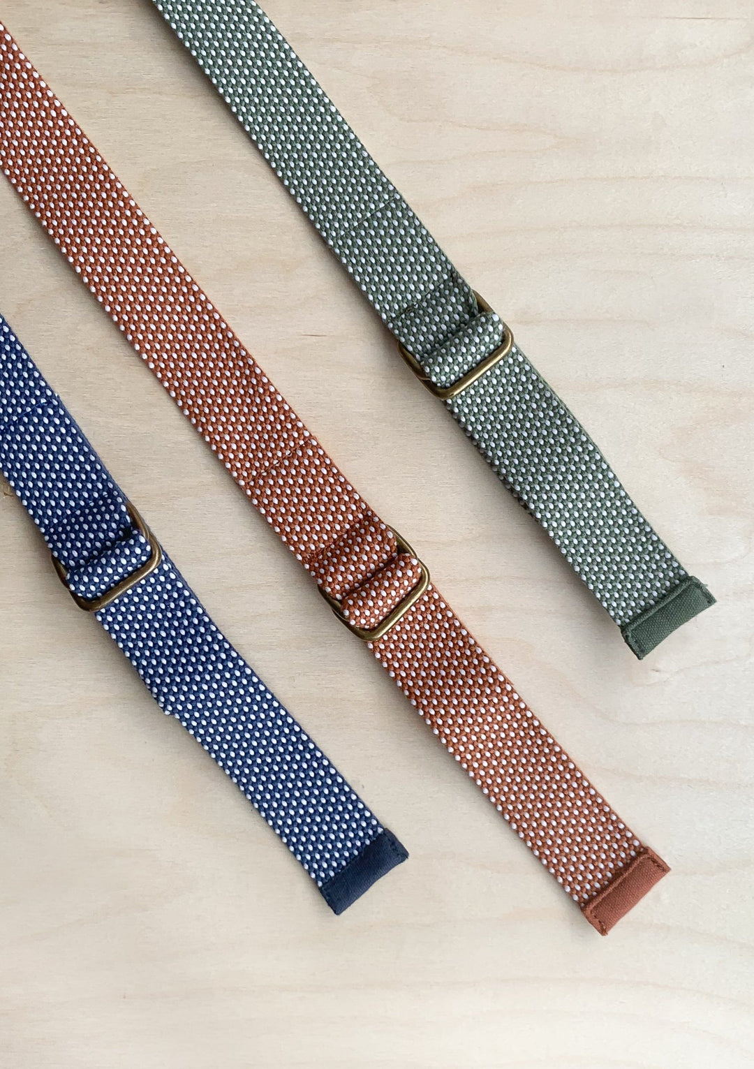 TBCo Recycled Long Shoulder Picnic Straps in navy, olive and rust, crafted from sustainable materials for effortless carrying of picnic blankets. Featuring an adjustable design and durable construction, perfect for outdoor adventures.