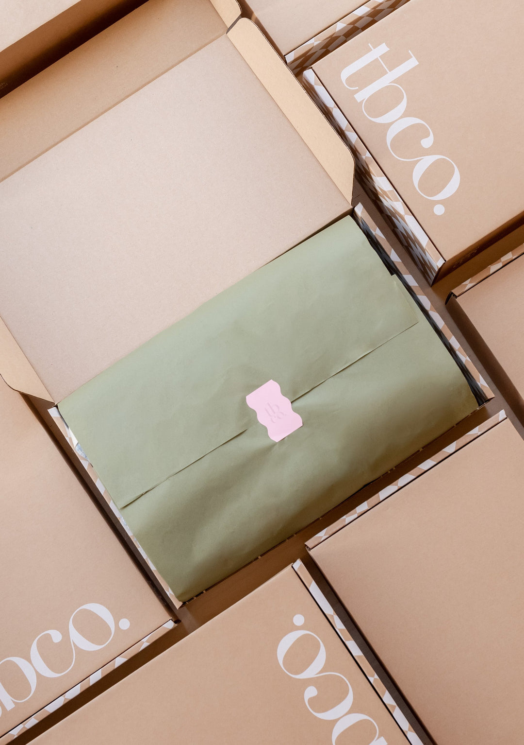 TBCo eco-friendly packaging featuring a premium wool blanket wrapped in a sustainable recycled cardboard box with elegant branding. Designed for thoughtful gifting, the packaging highlights TBCo's commitment to sustainability and high quality craftsmanship.