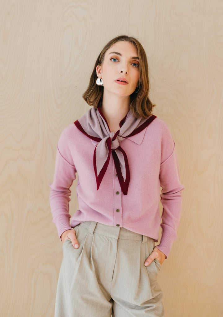 TBCo Merino Triangle Scarf in lilac and burgundy styled with pink cardigan, elegantly draped in bow-tie fashion