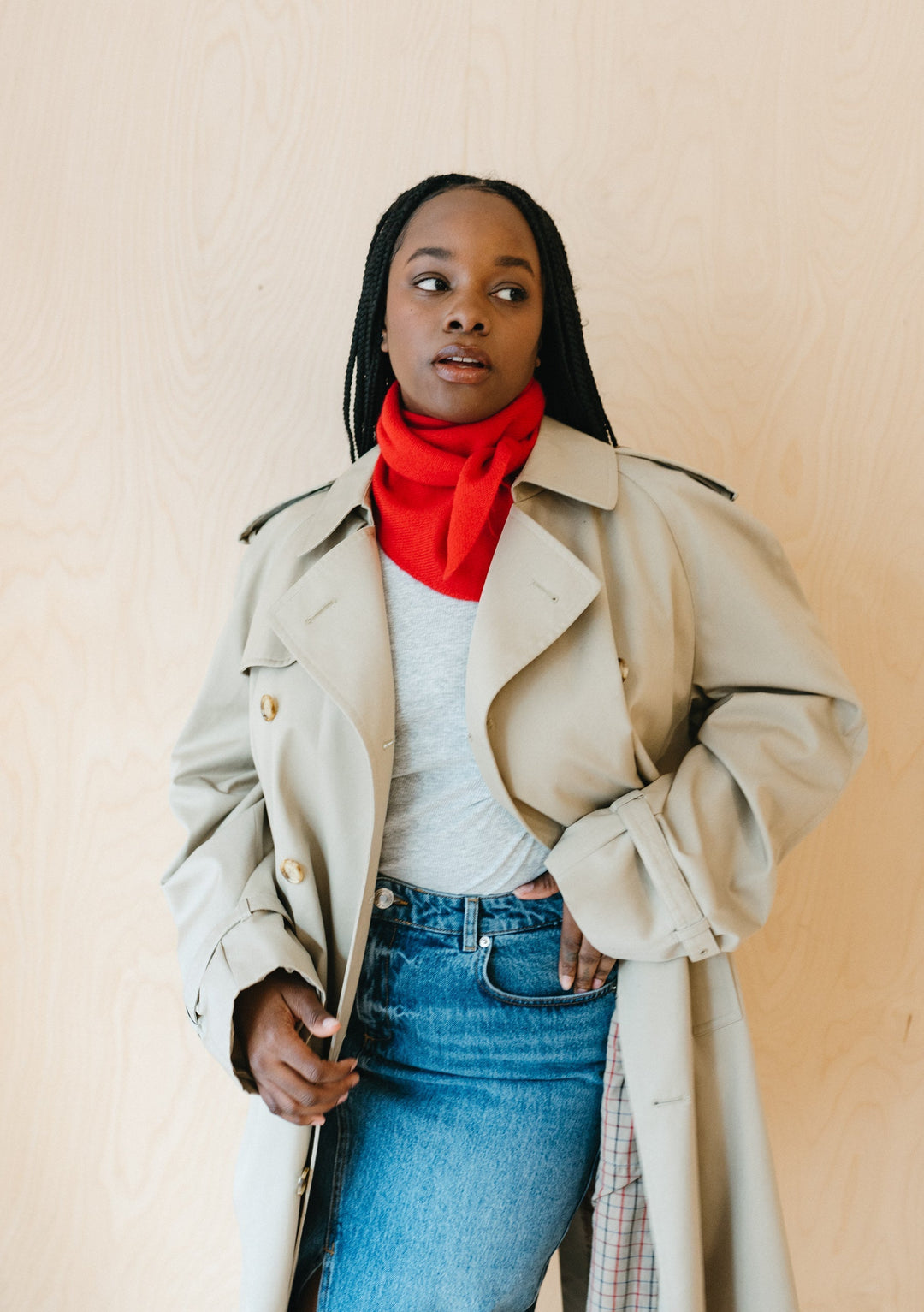 Bright red TBCo Merino Triangle Scarf styled with beige trench coat and denim, showcasing versatile winter layering