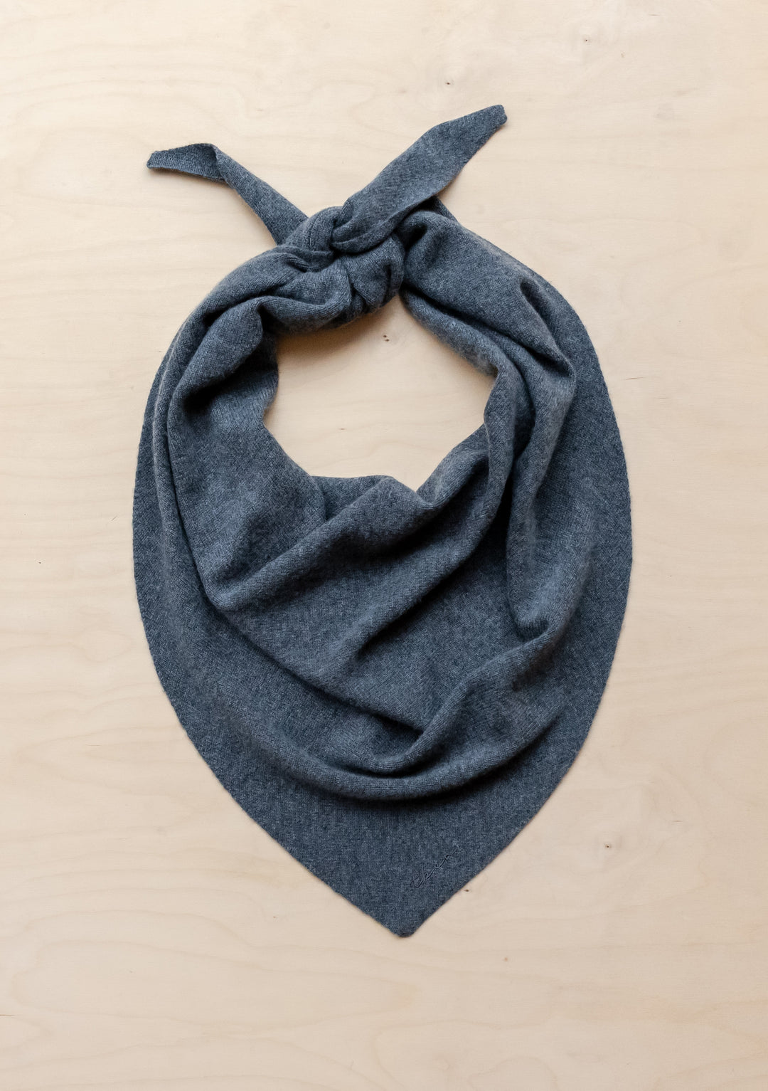 TBCo Large Merino Triangle Scarf in charcoal grey, elegantly draped and knotted to showcase its soft wool texture and versatile styling