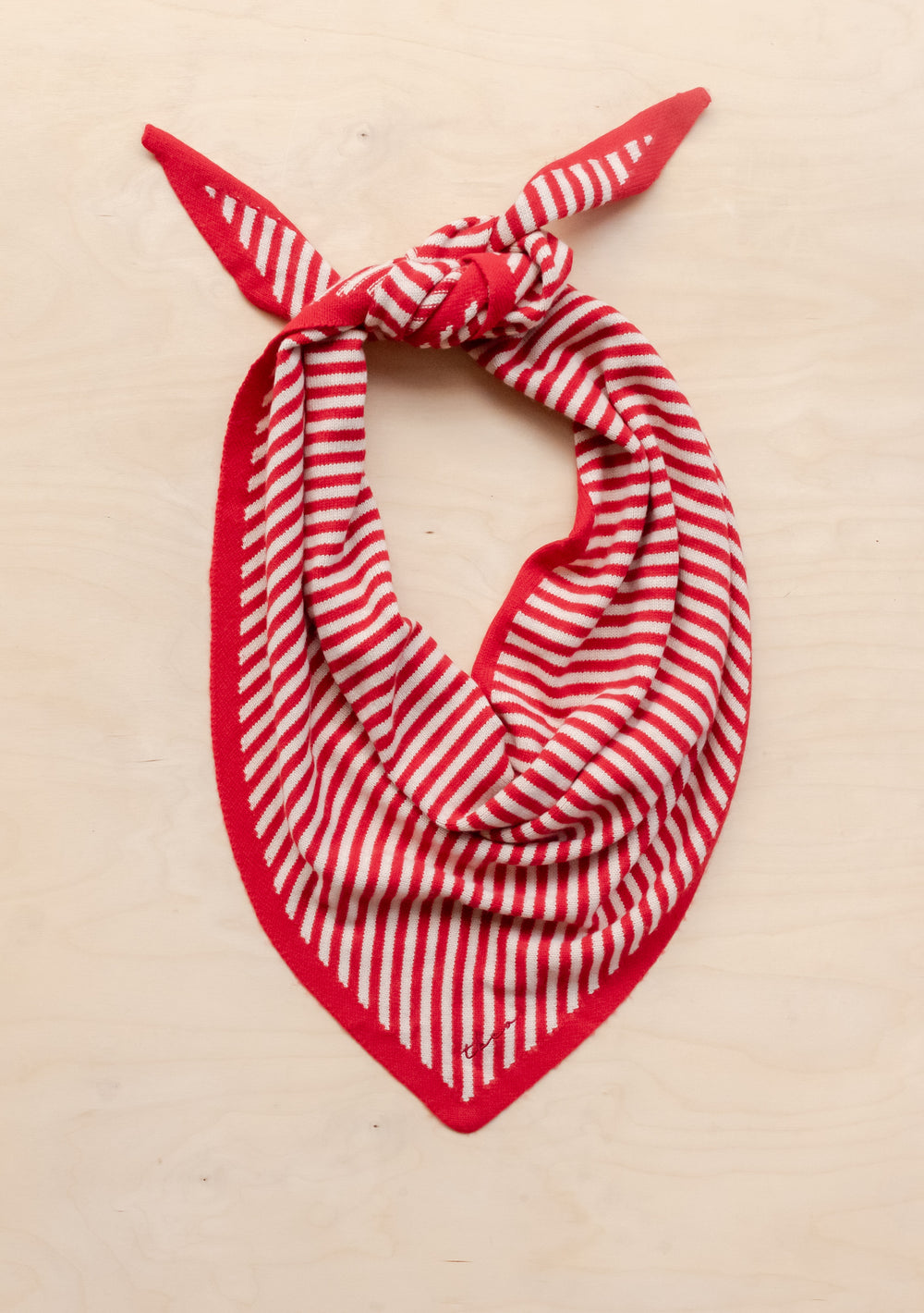 TBCo Large Merino Triangle Scarf in red and cream stripes, styled as a bandana with corner knot on cream background