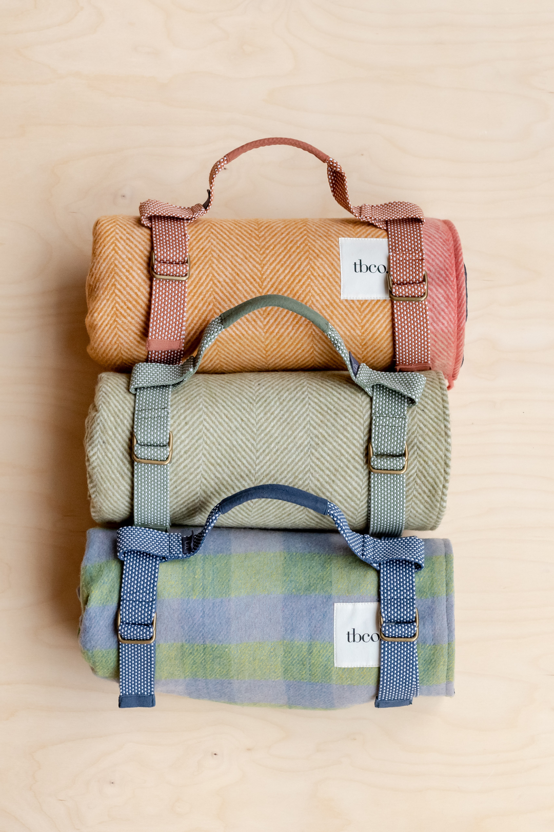 Couverture de pique-nique en laine recyclée à rayures orange.