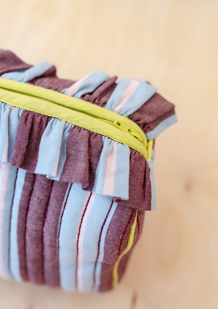 TBCo x Glassette Cotton Wash Bag in Berry Stripe, featuring quilted fabric, ruffled trim, chartreuse zipper, and multiple compartments, perfect for storing toiletries.