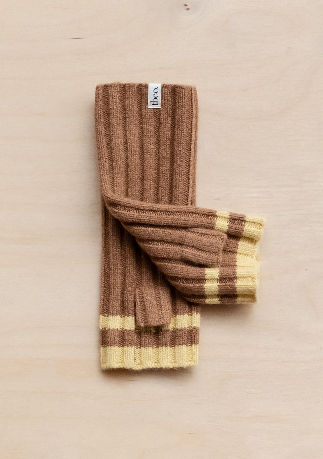 TBCo Cashmere & Merino Wrist Warmers in brown and buttermilk stripe pattern, featuring ribbed texture and luxury wool blend design