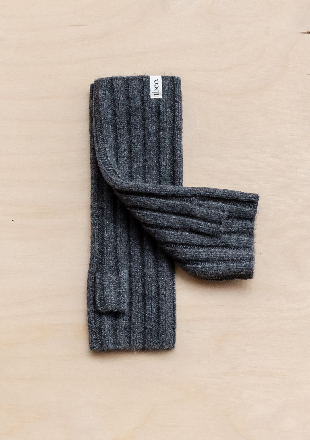 TBCo Cashmere & Merino Wrist Warmers in Charcoal Melange displayed flat showing ribbed texture and soft wool blend construction